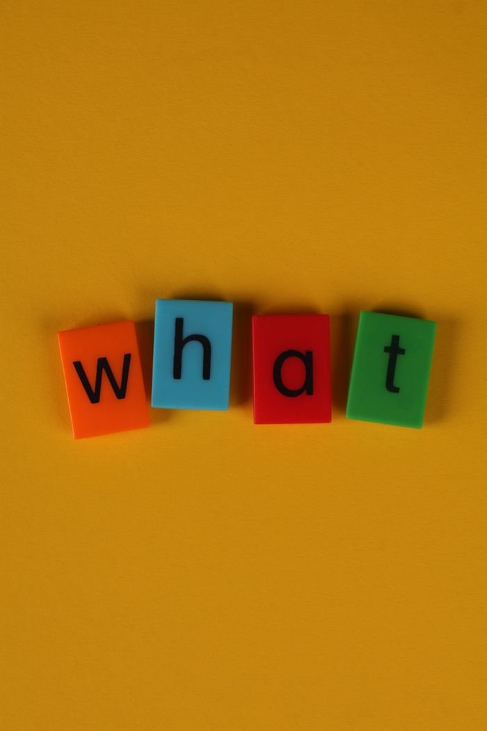 Colorful letter blocks spelling 'what' on yellow background, great for educational and creative content.
