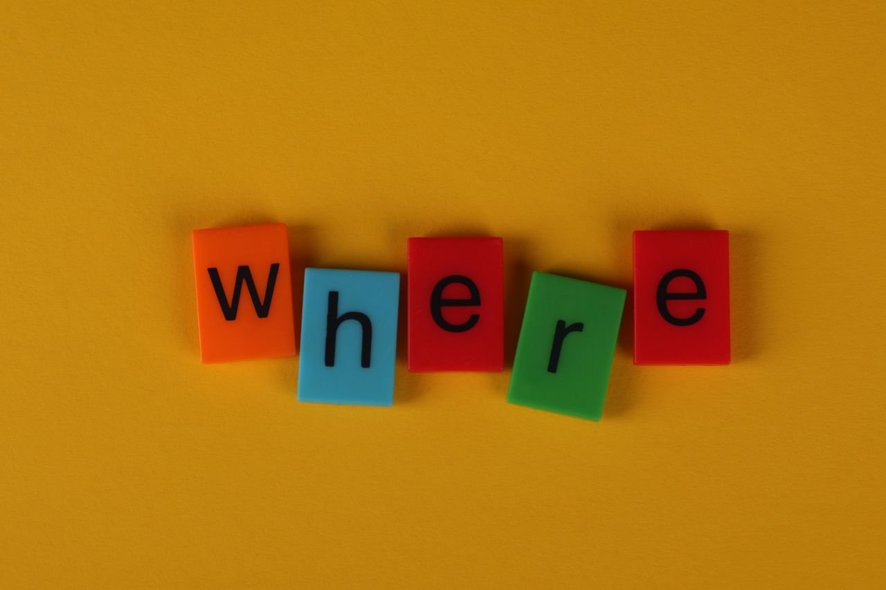 Colorful letter blocks arranged on yellow background spelling 'Where'.